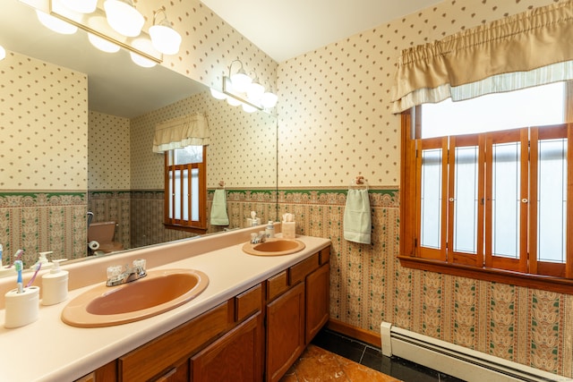 bathroom featuring a wealth of natural light, tile patterned flooring, a baseboard radiator, and toilet