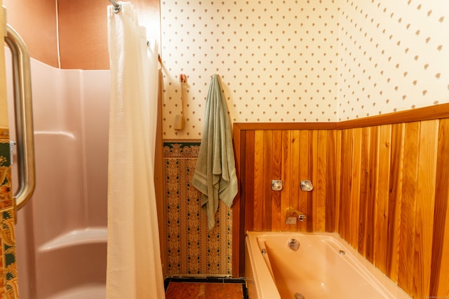 bathroom with wood walls and shower / tub combo