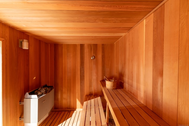 view of sauna / steam room featuring hardwood / wood-style floors, wood walls, and wooden ceiling