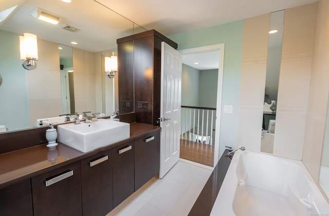 bathroom featuring recessed lighting, tile patterned floors, a bath, and vanity