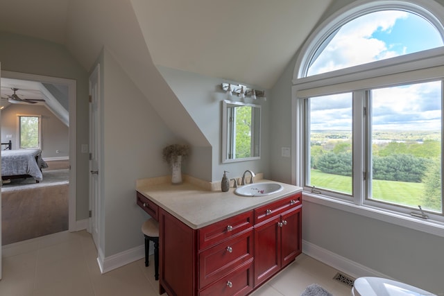 bathroom featuring visible vents, baseboards, and vaulted ceiling