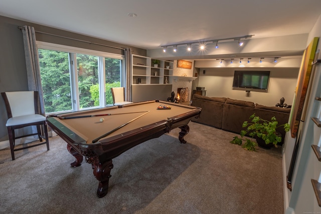 game room featuring carpet flooring, pool table, rail lighting, and a lit fireplace