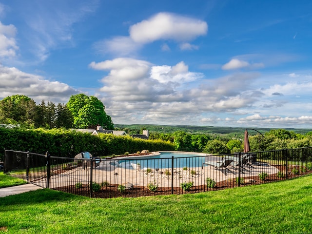 view of swimming pool with fence, a fenced in pool, and a yard