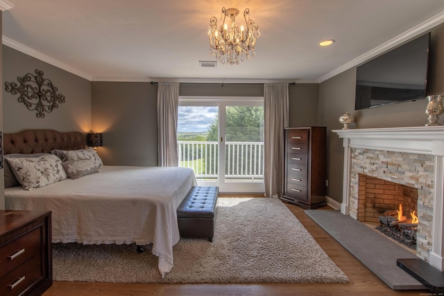 bedroom with visible vents, access to exterior, wood finished floors, an inviting chandelier, and ornamental molding