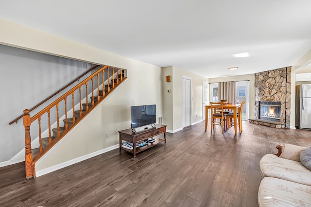 living room featuring wood-type flooring and a fireplace