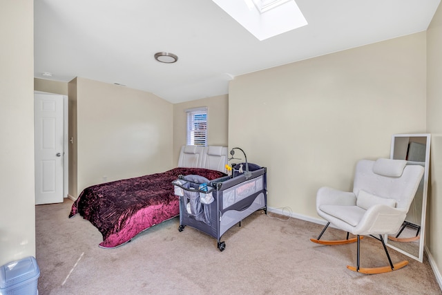 carpeted bedroom with lofted ceiling with skylight