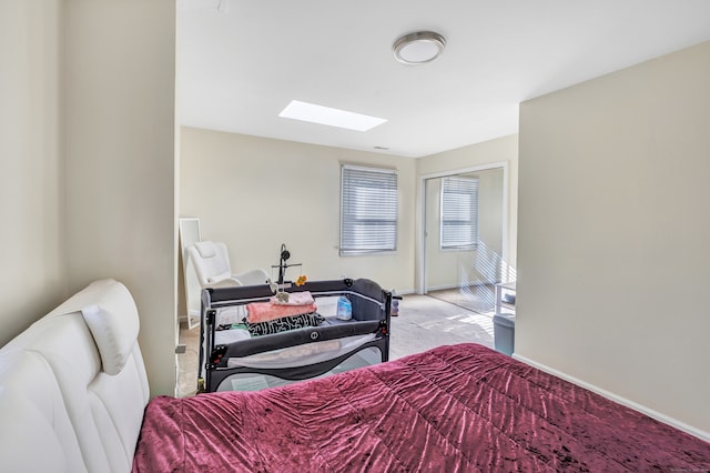 carpeted bedroom with a skylight