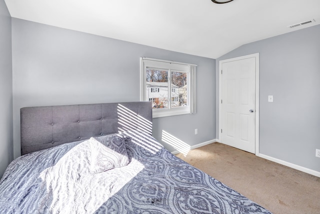 bedroom with carpet flooring and vaulted ceiling