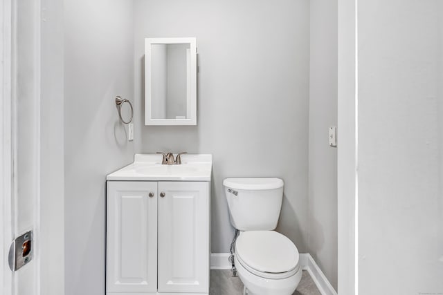 bathroom featuring tile patterned flooring, vanity, and toilet