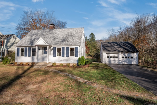 view of front of home featuring a front lawn, a garage, and an outdoor structure