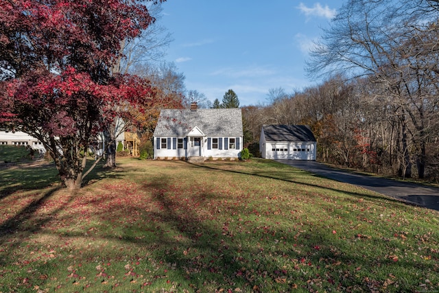 cape cod-style house with an outdoor structure and a front lawn