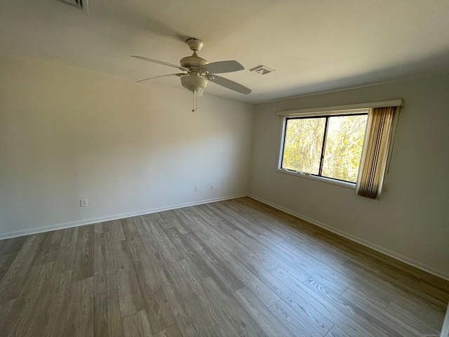 empty room featuring hardwood / wood-style floors and ceiling fan