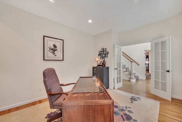 office area with french doors and light hardwood / wood-style flooring