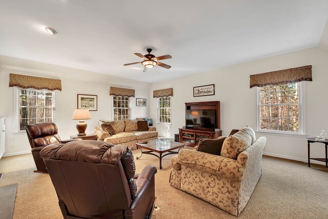 living room featuring a wealth of natural light, ceiling fan, and light colored carpet