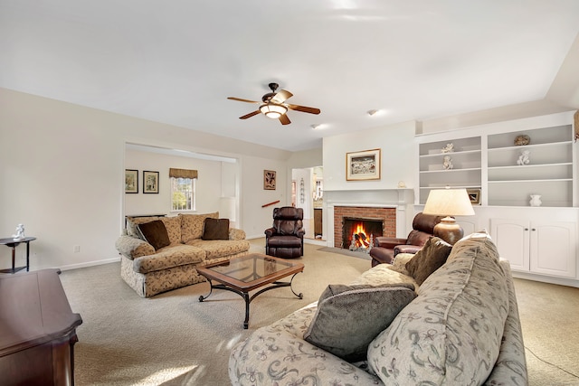 living room with a fireplace, ceiling fan, and light carpet