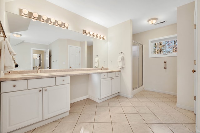 bathroom with vanity, tile patterned floors, and an enclosed shower