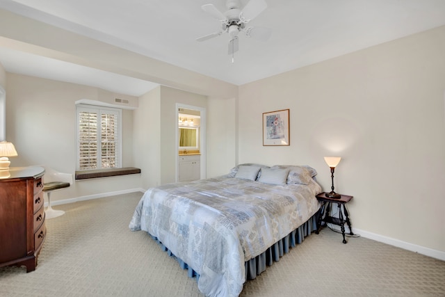 carpeted bedroom with connected bathroom and ceiling fan