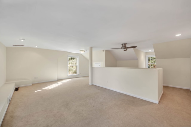 unfurnished room featuring ceiling fan, lofted ceiling, and light carpet