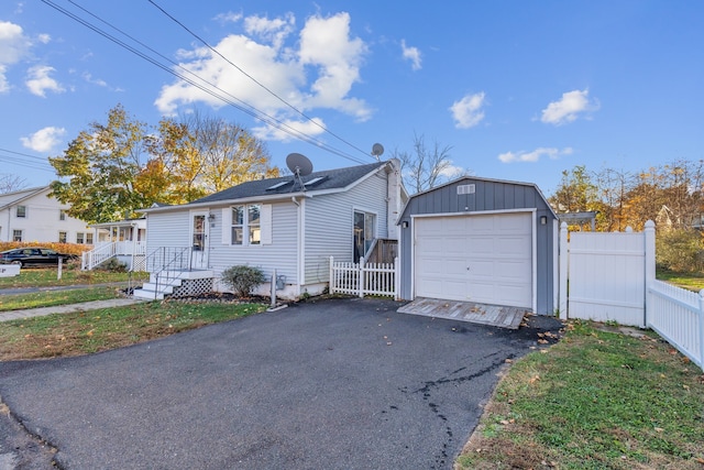 view of front of property with a garage and an outdoor structure