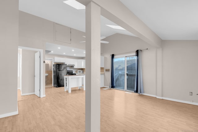 unfurnished living room featuring light hardwood / wood-style floors and lofted ceiling