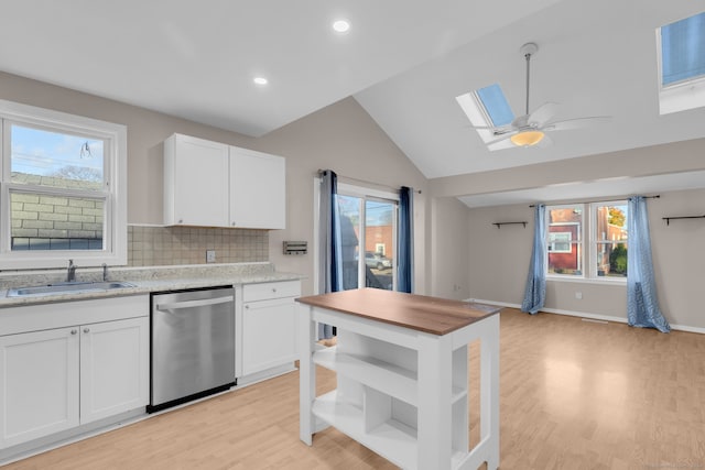 kitchen with white cabinetry, dishwasher, a healthy amount of sunlight, and sink