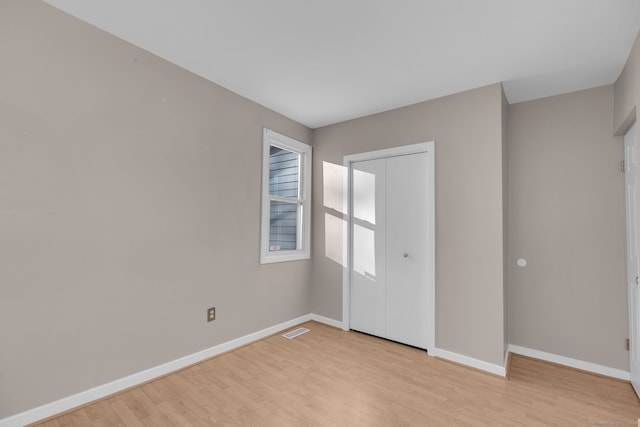 unfurnished room featuring light wood-type flooring