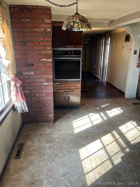 kitchen with dark brown cabinetry and black oven