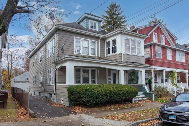 233 Pearl St, Middletown, CT 06457 - view of front facade with covered porch, an outdoor structure, and a detached garage
