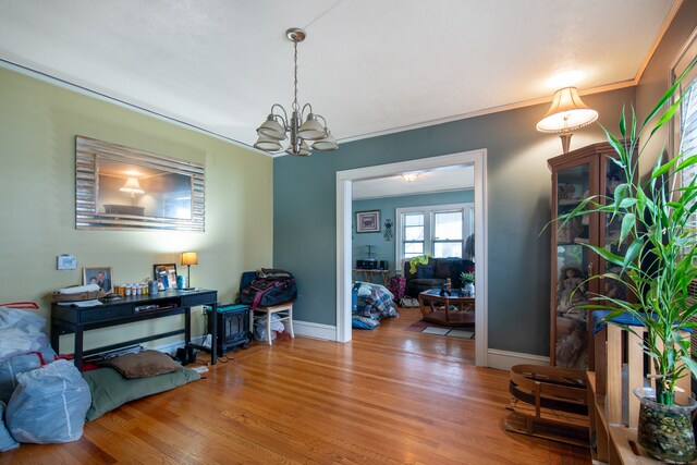 interior space featuring ornamental molding, hardwood / wood-style floors, and an inviting chandelier