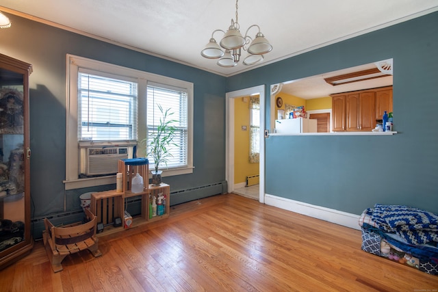 233 Pearl St, Middletown, CT 06457 - living area with baseboard heating, a chandelier, light wood-style floors, and crown molding