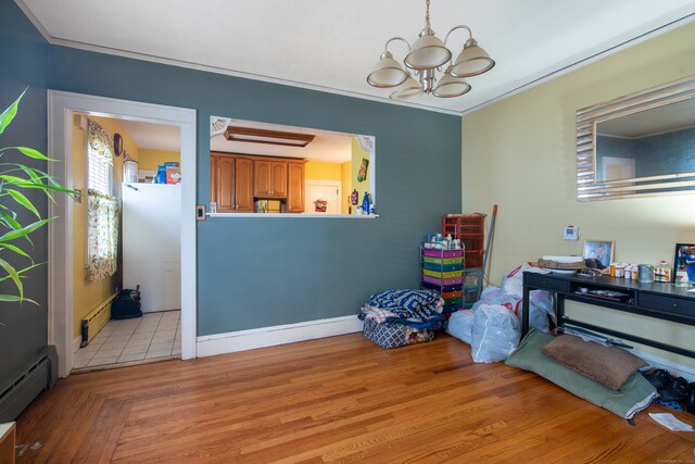 misc room featuring a baseboard radiator, a chandelier, light hardwood / wood-style floors, and crown molding