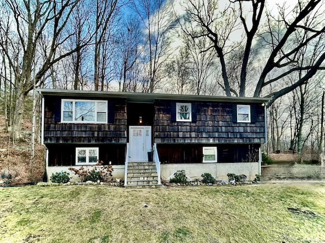 raised ranch with a front yard