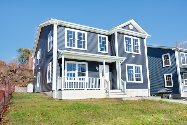 view of front of home featuring a porch and a front lawn