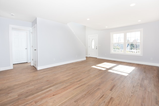 unfurnished living room featuring light wood-type flooring