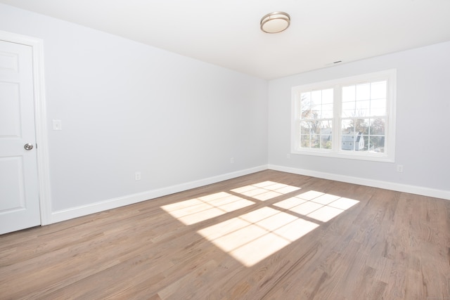 empty room with light hardwood / wood-style flooring