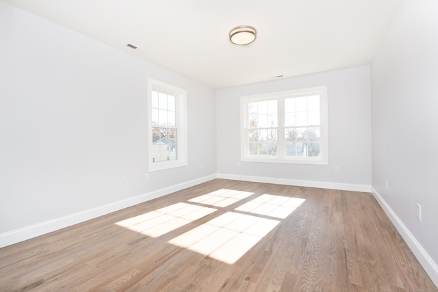 spare room with light hardwood / wood-style floors