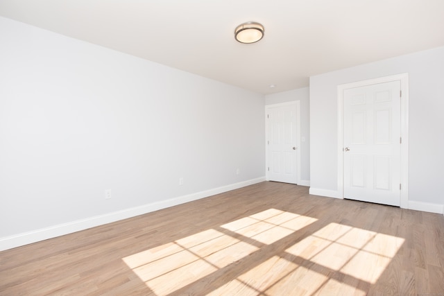 spare room with light hardwood / wood-style flooring