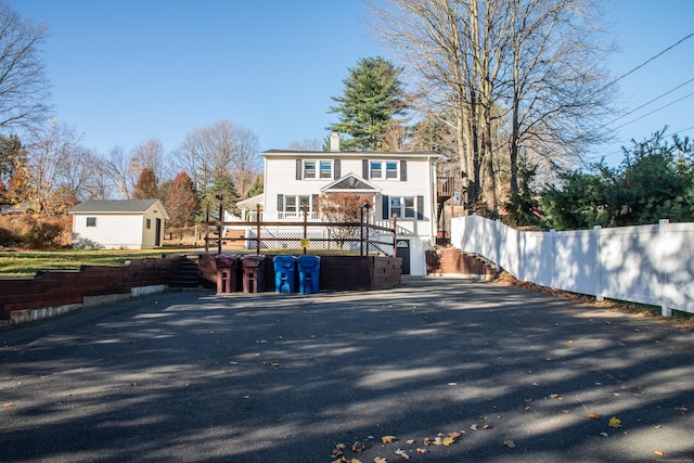 rear view of property featuring a deck