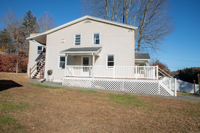 back of house with a lawn