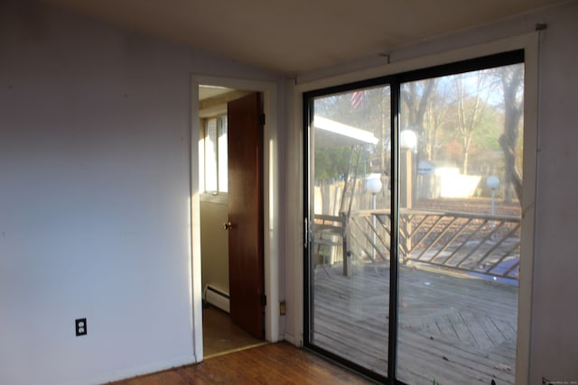 entryway featuring hardwood / wood-style flooring and a baseboard heating unit