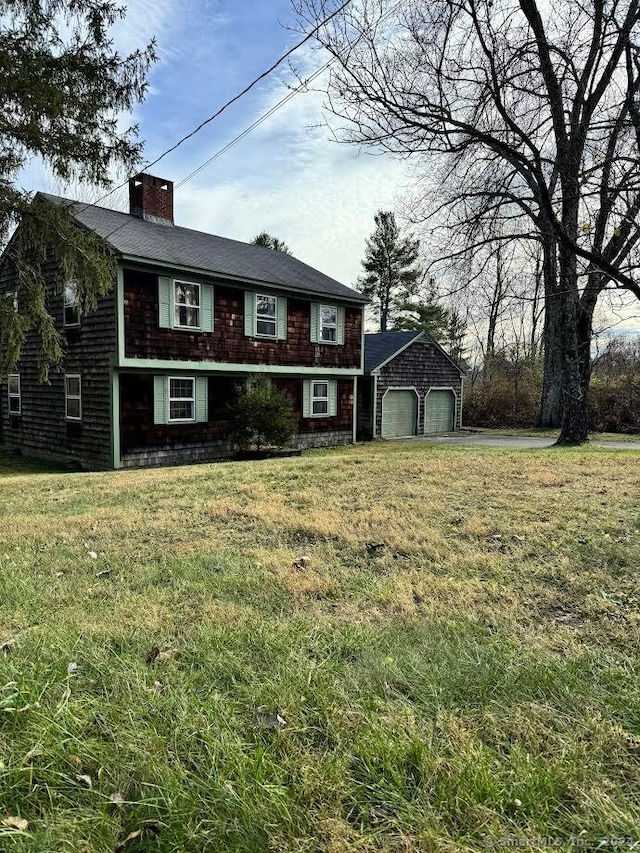 view of front of house featuring a garage and a front lawn