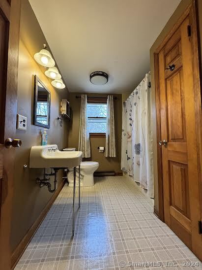 bathroom featuring toilet and a wall mounted air conditioner