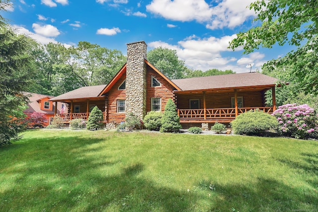 rear view of property featuring a yard