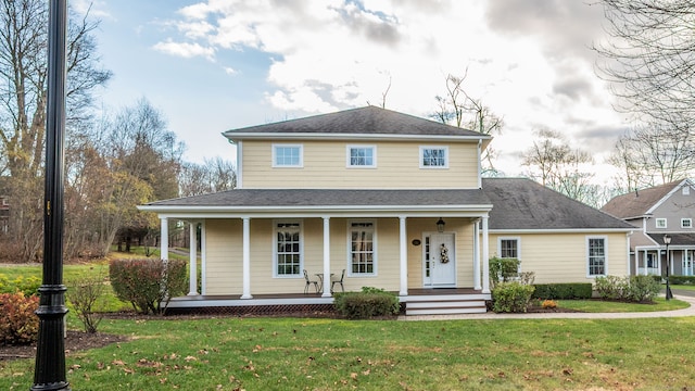 view of front of property featuring covered porch and a front lawn