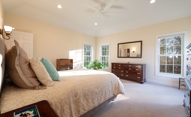 bedroom featuring light carpet and ceiling fan