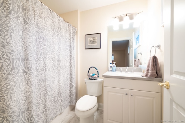 bathroom featuring toilet, vanity, and tile patterned flooring