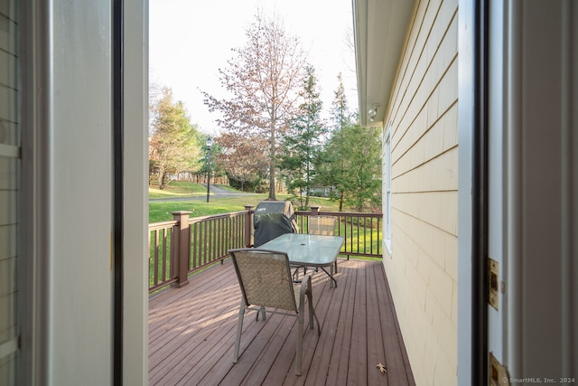 wooden deck with a lawn