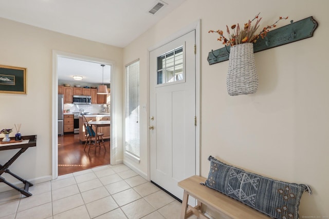 foyer with light wood-type flooring