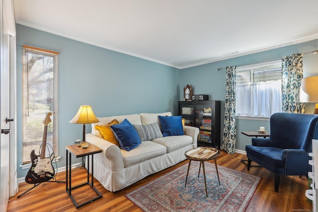 living room with ornamental molding, a healthy amount of sunlight, and hardwood / wood-style flooring