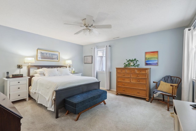 bedroom with ceiling fan and light colored carpet